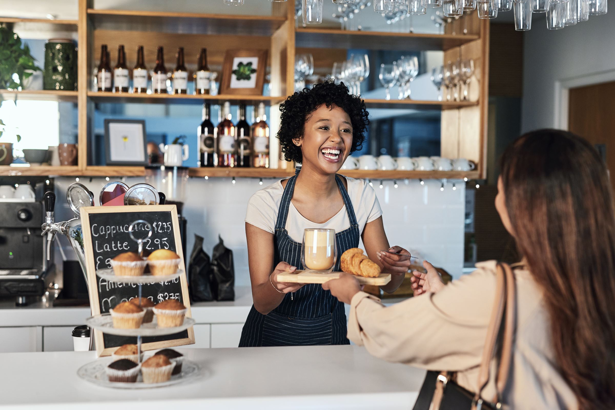 A café owner serving a customer